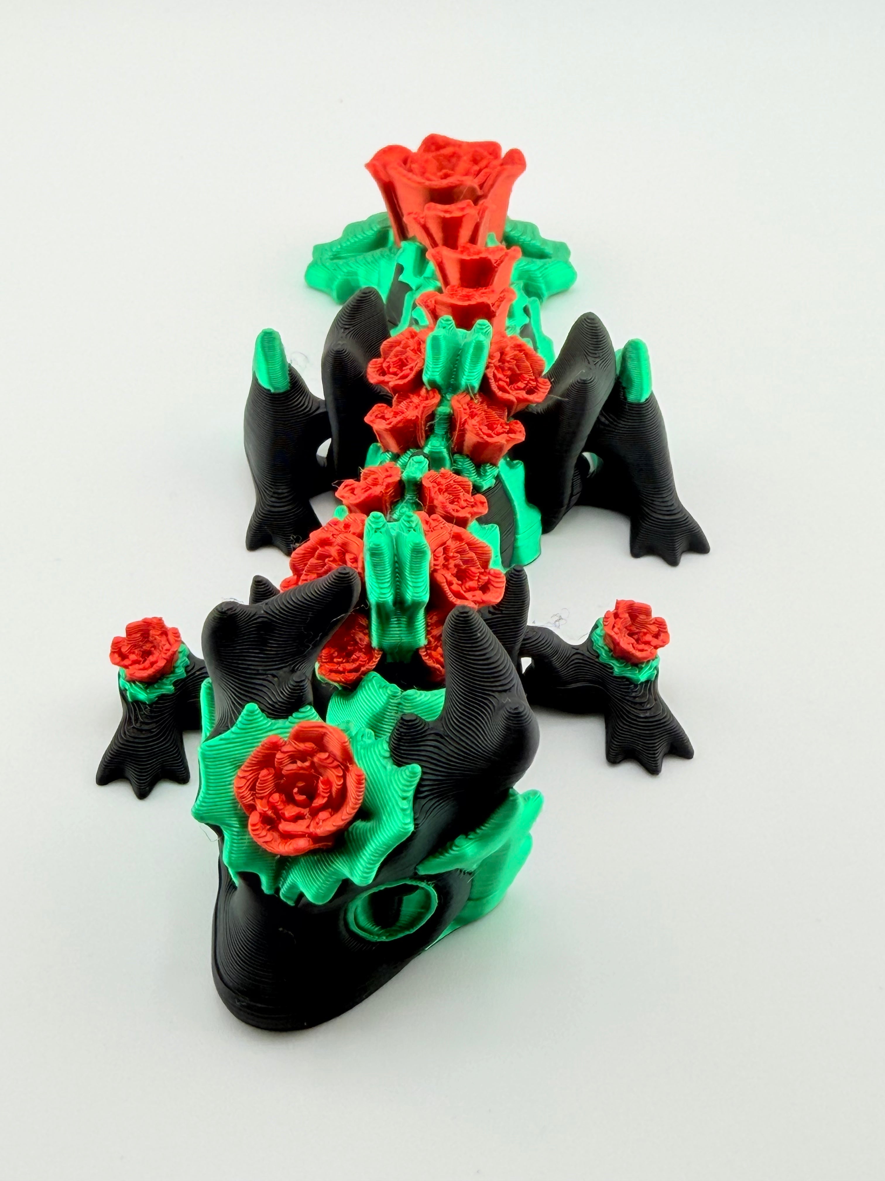 3D printed black dragon with red roses
