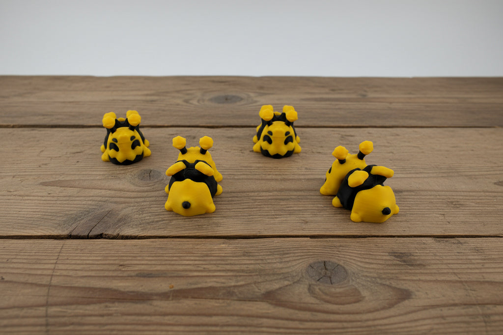 3D printed mini bees on farm table